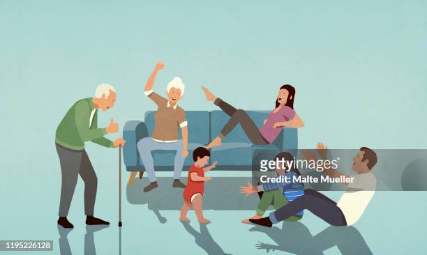 happy multi-generation family cheering in living room - family stock illustrations