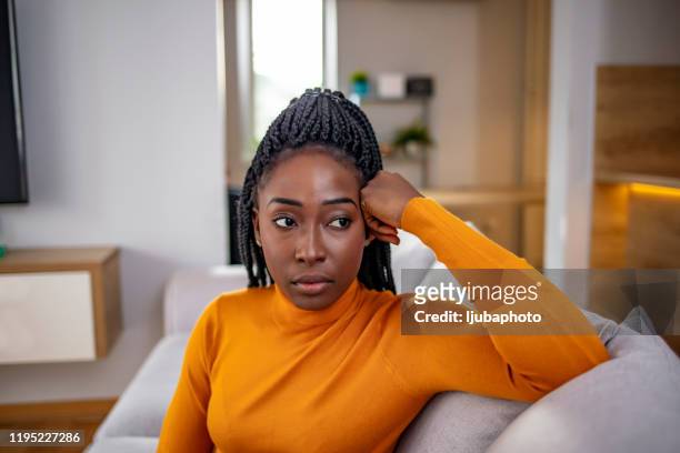 young attractive and sad black african american woman sitting depressed at home - angry black woman stock pictures, royalty-free photos & images