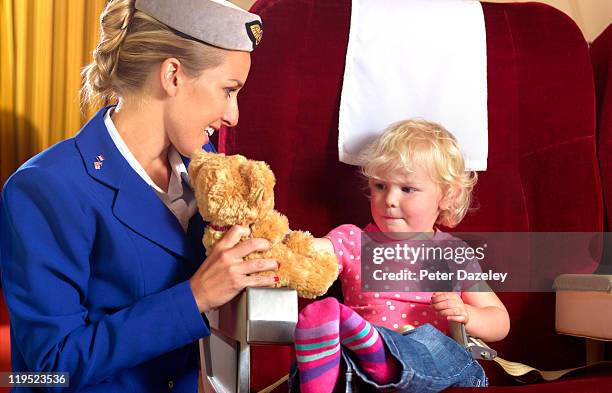 air hostess entertaining child on airplane - air stewardess stockfoto's en -beelden