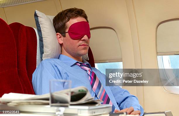 man asleep in business class on plane - first class plane stock-fotos und bilder