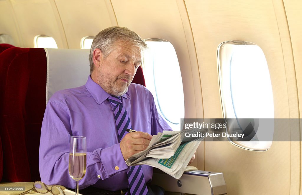Mature man in business class on airplane