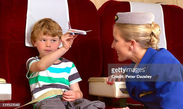 air hostess with child on plane - air stewardess stockfoto's en -beelden