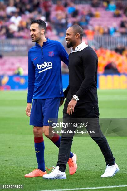 Sergio Busquets of FC Barcelona walks with former teammate Seydou Keita before the La Liga match between FC Barcelona and Deportivo Alaves at Camp...