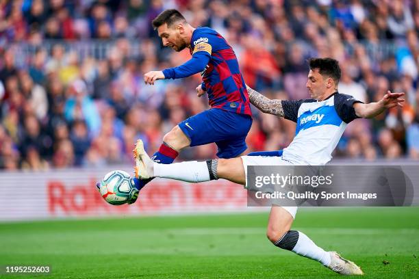 Lionel Messi of FC Barcelona competes for the with Ximo Navarro of Deportivo Alaves during the Liga match between FC Barcelona and Deportivo Alaves...