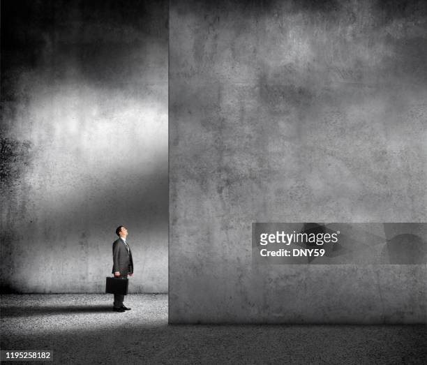 small businessman in overwhelming environment - overcoming problems stock pictures, royalty-free photos & images