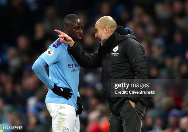 Pep Guardiola, Manager of Manchester City talks to Benjamin Mendy of Manchester City during the Premier League match between Manchester City and...