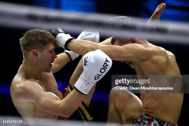 Serhii Adamchuk of Ukraine battles with Aleksei Ulianov of Russia during their Featherweight kickboxing bout at GLORY 74 Arnhem / Collision 2 prior...