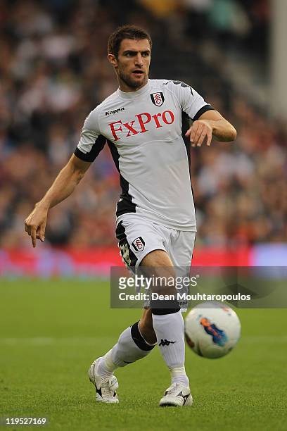 Aaron Hughes of Fulham passes the ball during the UEFA Europa League 2nd Qualifying Round 2nd Leg match between Fulham and Crusaders at Craven...