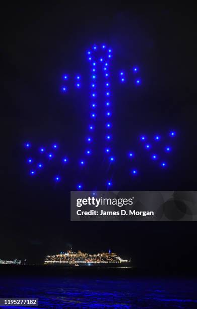 The anchor of a ship made up of illuminated drones with the Cunard ship Queen Elizabeth in the background on December 22, 2019 in Melbourne,...