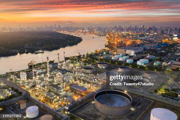 aerial view oil and gas industrial, refinery factory oil storage tank and pipeline steel at sunset - united arab emirates aerial stock pictures, royalty-free photos & images