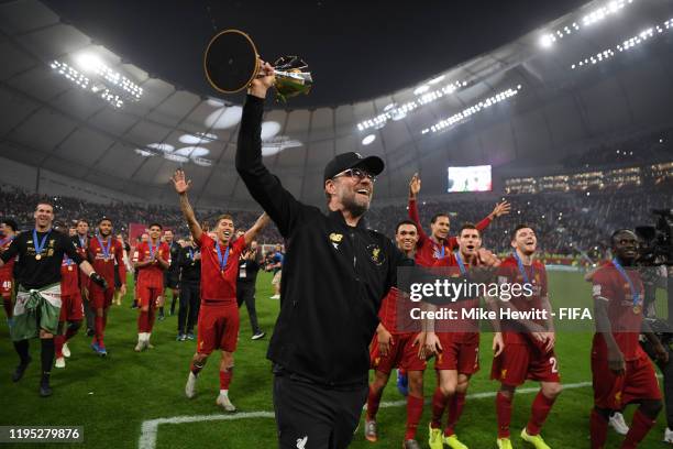 Jurgen Klopp, Manager of Liverpool celebrates with the FIFA Club World Cup Qatar 2019 trophy during a lap of honor following their victory in the...