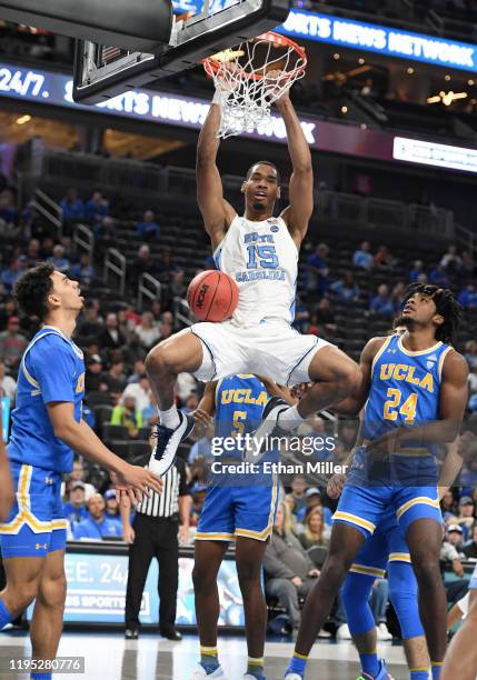 Garrison Brooks of the North Carolina Tar Heels dunks against Jules Bernard and Jalen Hill of the UCLA Bruins during the CBS Sports Classic at...