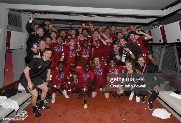 Liverpool players and staff with the FIFA Club World Cup in the dressing room at the end of the the FIFA Club World Cup final match between Liverpool...