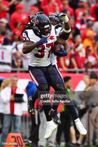 Jahleel Addae of the Houston Texans celebrates with Tashaun Gipson after intercepting Jameis Winston of the Tampa Bay Buccaneers during the fourth...