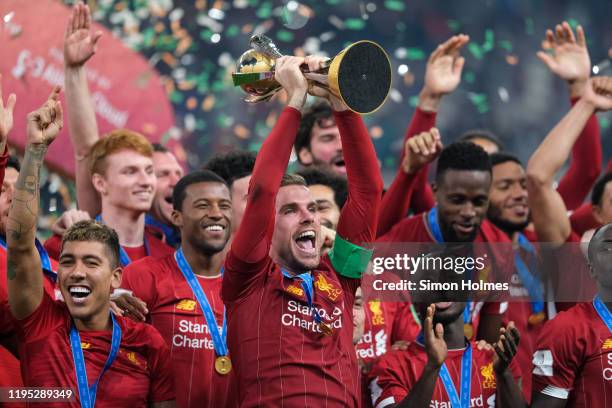 Liverpool captain, Jordan Henderson, lifts the Club World Cup after his team's 1-0 victory over CR Flamengo at Khalifa International Stadium on...