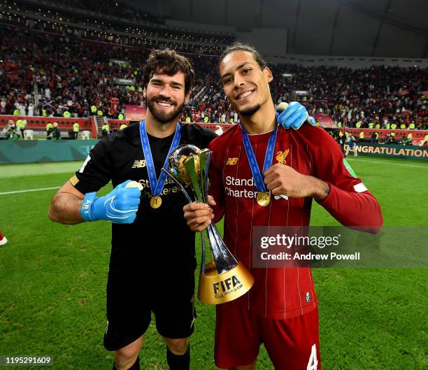 Alisson Becker and Virgil van Dijk of Liverpool with the FIFA Club World Cup at the end of the FIFA Club World Cup final match between Liverpool FC...