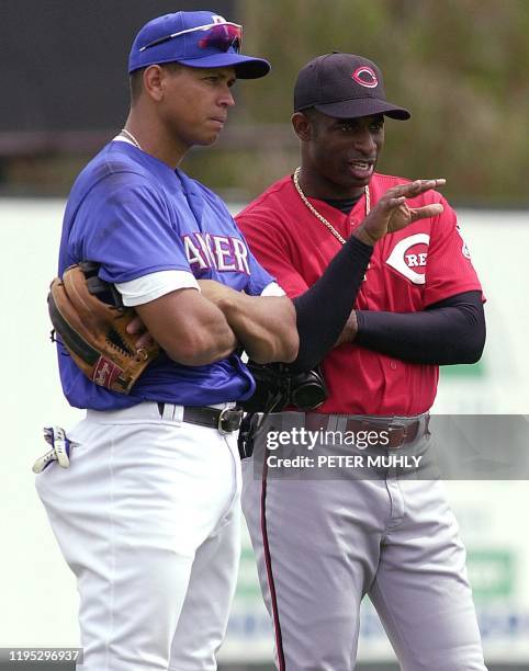 Texas Ranger Alex Rodriguez talks with Cincinnati Reds Deion Sanders 15 March 2001 during batting practice at Charlotte County Stadium in Port...