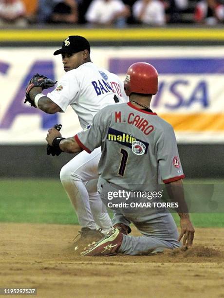 Jose Ortiz , second baseman for the Aguilas de Cibao team of the Dominican Republic, throws are double play, striking out Venezuelan player Miguel...