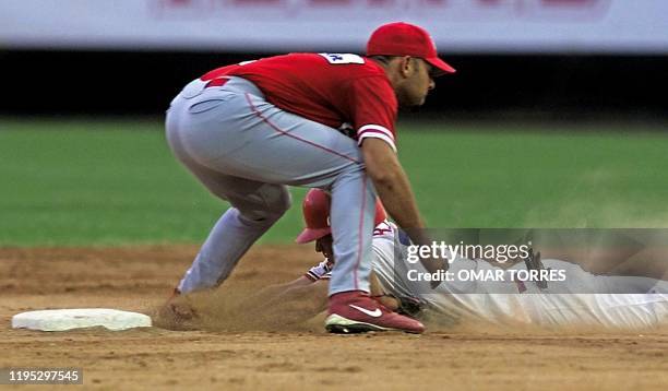 Alex Cora , player for los Criollos of Puerto Rico strikes out Ryan Freel of the Los Cardenales de Lara of Venezuela, 07 February 2001 in Culiacan,...