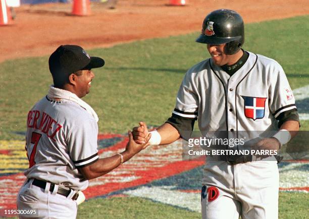Felix Fermin of the Dominican Republic is greeted by his coach after hitting a home run 07 February. Feliz Fermin de Republica Dominicana es saludado...