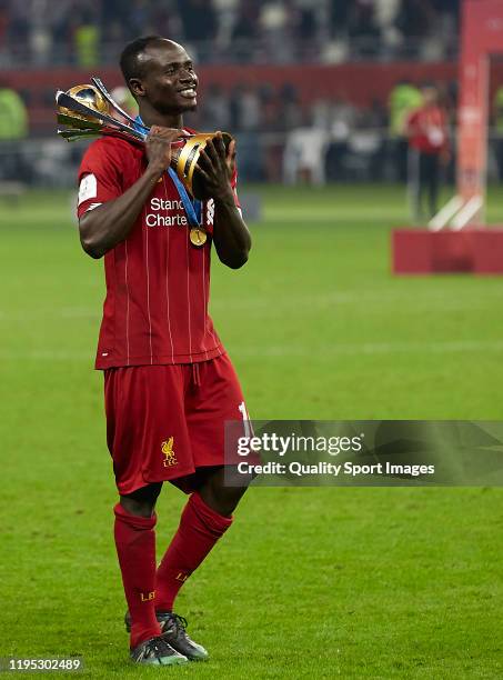 Sadio Mane of Liverpool celebrates with the trophy after the FIFA Club World Cup Final between Liverpool and Flamengo at Khalifa Stadium on December...