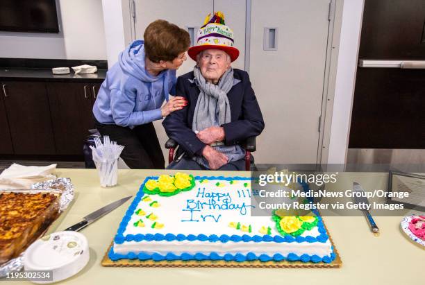 Penny Grossman, left, talks with her friend Laguna Woods resident Irving Piken, during his 111th birthday celebration at the Laguna Woods Community...