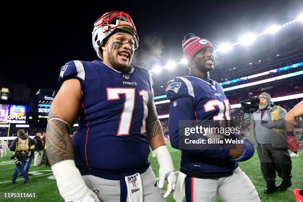 Danny Shelton and Jason McCourty of the New England Patriots leave the field after the Patriots defeated the Bills 24-17 in the game at Gillette...