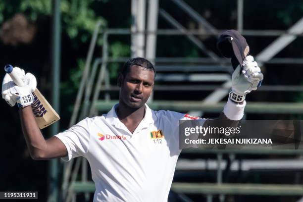 Sri Lanka's batsman Angelo Mathews celebrates reaching 200 runs during the fourth day of the first Test cricket match between Zimbabwe and Sri Lanka...