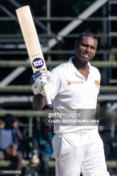 Sri Lanka's batsman Angelo Mathews celebrates reaching 200 runs during the fourth day of the first Test cricket match between Zimbabwe and Sri Lanka...