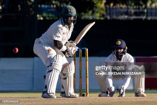 Zimbabwe's batsman Prince Masvaure prepares to hit the ball past wicket keeper Niroshan Dickwella during the fourth day of the first Test cricket...