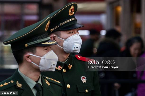 Chinese police officers wear protective masks at Beijing Station before the annual Spring Festival on January 22, 2020 in Beijing, China. The number...
