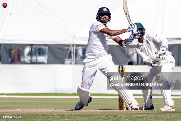 Sri Lanka batsman Suranga Lakmal bats as wicket keeper Regis Chakabva looks on during the fourth day of the first Test cricket match between Zimbabwe...