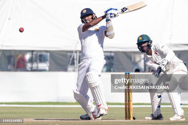 Sri Lanka batsman Suranga Lakmal bats as wicket keeper Regis Chakabva looks on during the fourth day of the first Test cricket match played between...