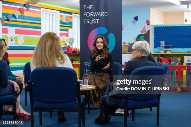 Britain's Catherine, Duchess of Cambridge speaks with Trustee Benny Refson and former prisoners who have received help with rehabilitation from the...