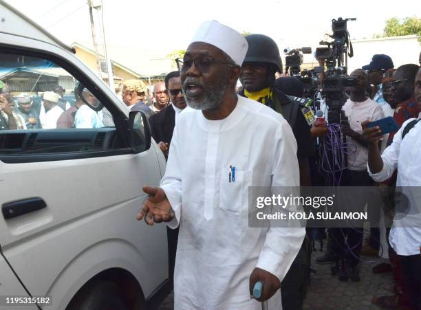 Mohammed Adoke, Nigeria's former attorney general, arrives to appear before a Federal High Court in Abuja, Nigeria's capital over financial crimes...