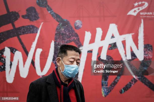 Man wears a mask while walking in the street on January 22, 2020 in Wuhan, Hubei province, China. A new infectious coronavirus known as "2019-nCoV"...