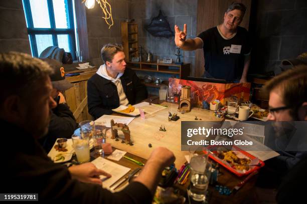 Robert Swift of Bedford, Mass. Holds out a die while serving as a dungeon master in a game of Dungeons and Dragons at the Adventure Pub in Arlington,...