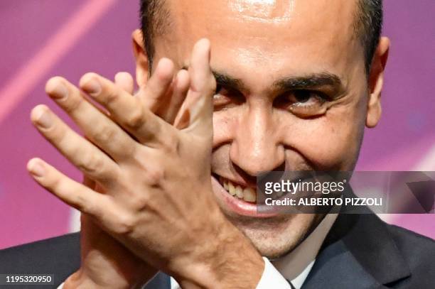Italy's Foreign Minister and outgoing head of Italy's anti-establishment Five Star Movement , Luigi Di Maio applauds after he delivered a speech...