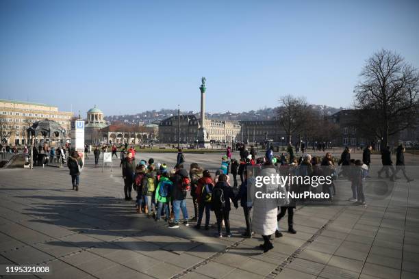 People walk during a sunny day in Stuttgart, Germany on January 22, 2020