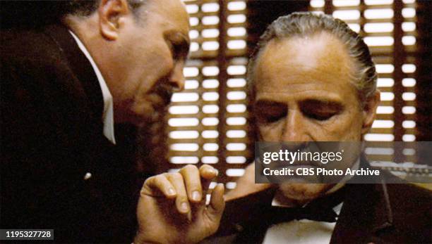 Salvatore Corsitto as Bonasera leans in to Don Vito Corleone, played by Marlon Brando in 'The Godfather, ' the movie based on the novel by Mario Puzo...