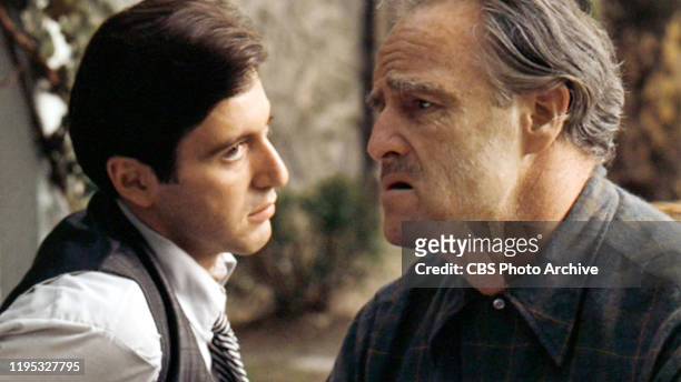Al Pacino as Michael Corleone and Marlon Brando as Don Vito Corleone in 'The Godfather, ' the movie based on the novel by Mario Puzo and directed by...