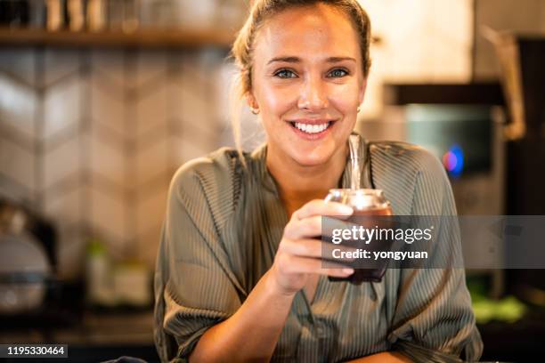 portrait of a beautiful young woman enjoying yerba mate - mate stock pictures, royalty-free photos & images
