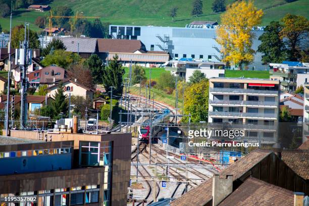 train arriving in the center of the city of bulle - bulle stock pictures, royalty-free photos & images