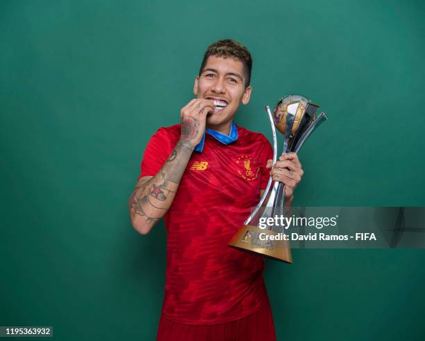 Roberto Firmino of Liverpool poses with the Club World Cup trophy after the FIFA Club World Cup Qatar 2019 Final match between Liverpool and CR...