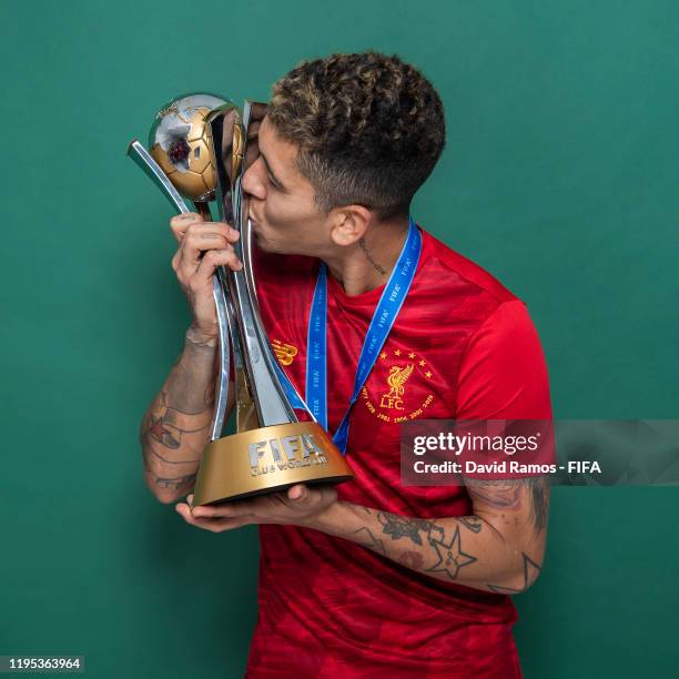 Roberto Firmino of Liverpool poses with the Club World Cup trophy after the FIFA Club World Cup Qatar 2019 Final match between Liverpool and CR...