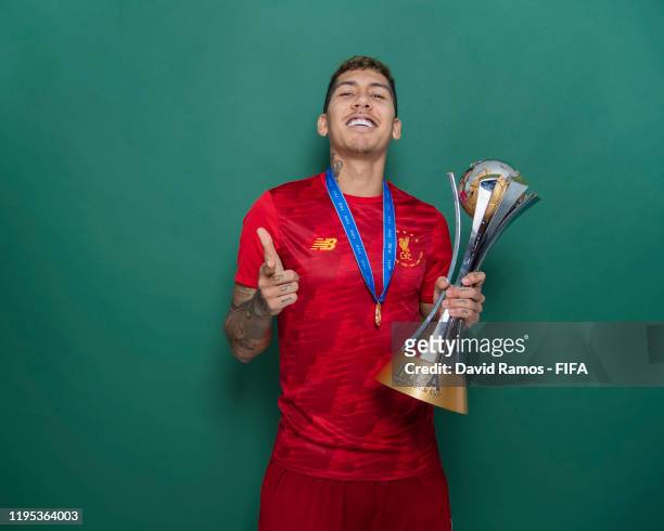Roberto Firmino of Liverpool poses with the Club World Cup trophy after the FIFA Club World Cup Qatar 2019 Final match between Liverpool and CR...