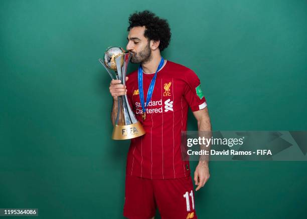 Mohamed Salah of Liverpool poses with the Club World Cup trophy after the FIFA Club World Cup Qatar 2019 Final match between Liverpool and CR...