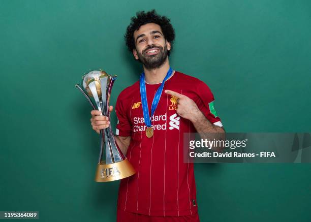 Mohamed Salah of Liverpool poses with the Club World Cup trophy after the FIFA Club World Cup Qatar 2019 Final match between Liverpool and CR...