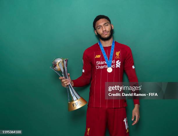 Joseph Gomez of Liverpool poses with the Club World Cup trophy after the FIFA Club World Cup Qatar 2019 Final match between Liverpool and CR Flamengo...