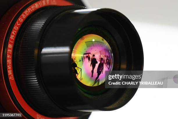 Passengers who arrived on one of the last flights from the Chinese city of Wuhan are reflected in the lens of an advanced thermo camera as they walk...